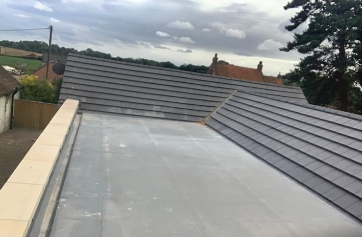 New flat roof beside pitched tiling
