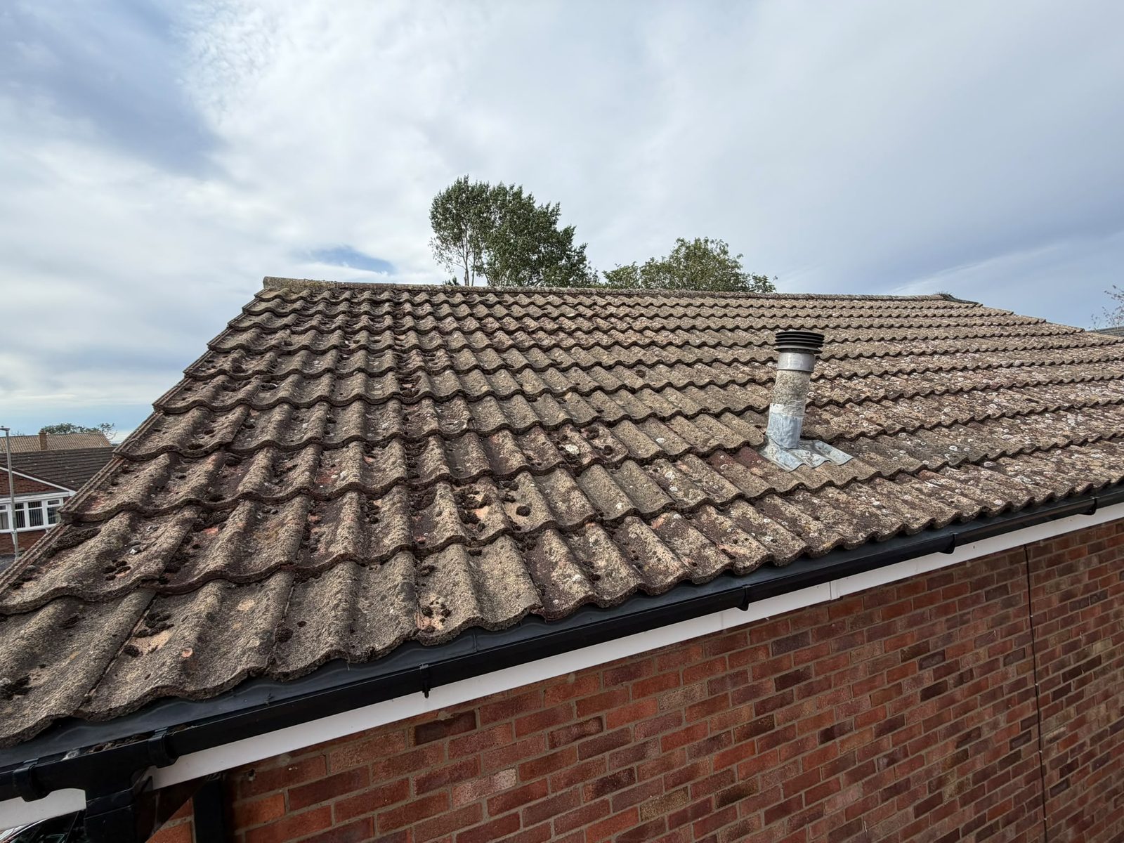 Old concrete pantiles worn through, laths and felt at the end of their life