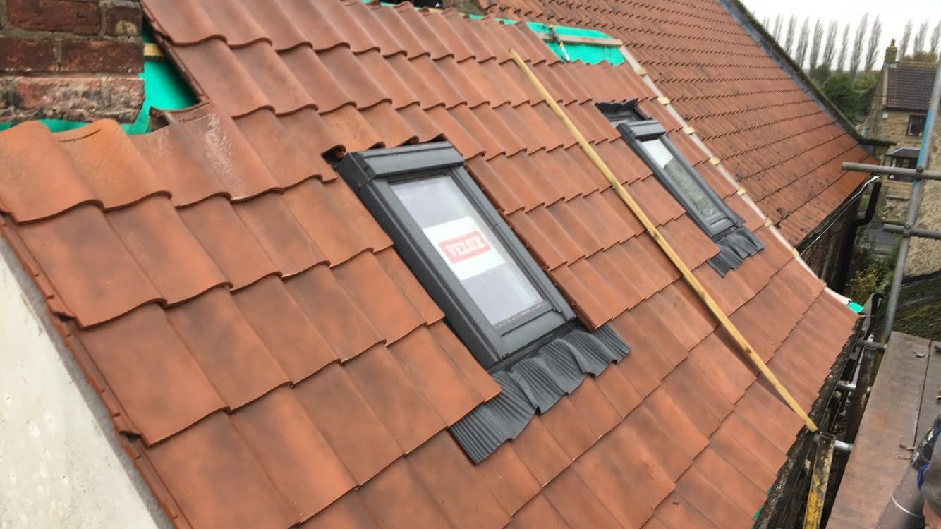 Roof window in new tiles